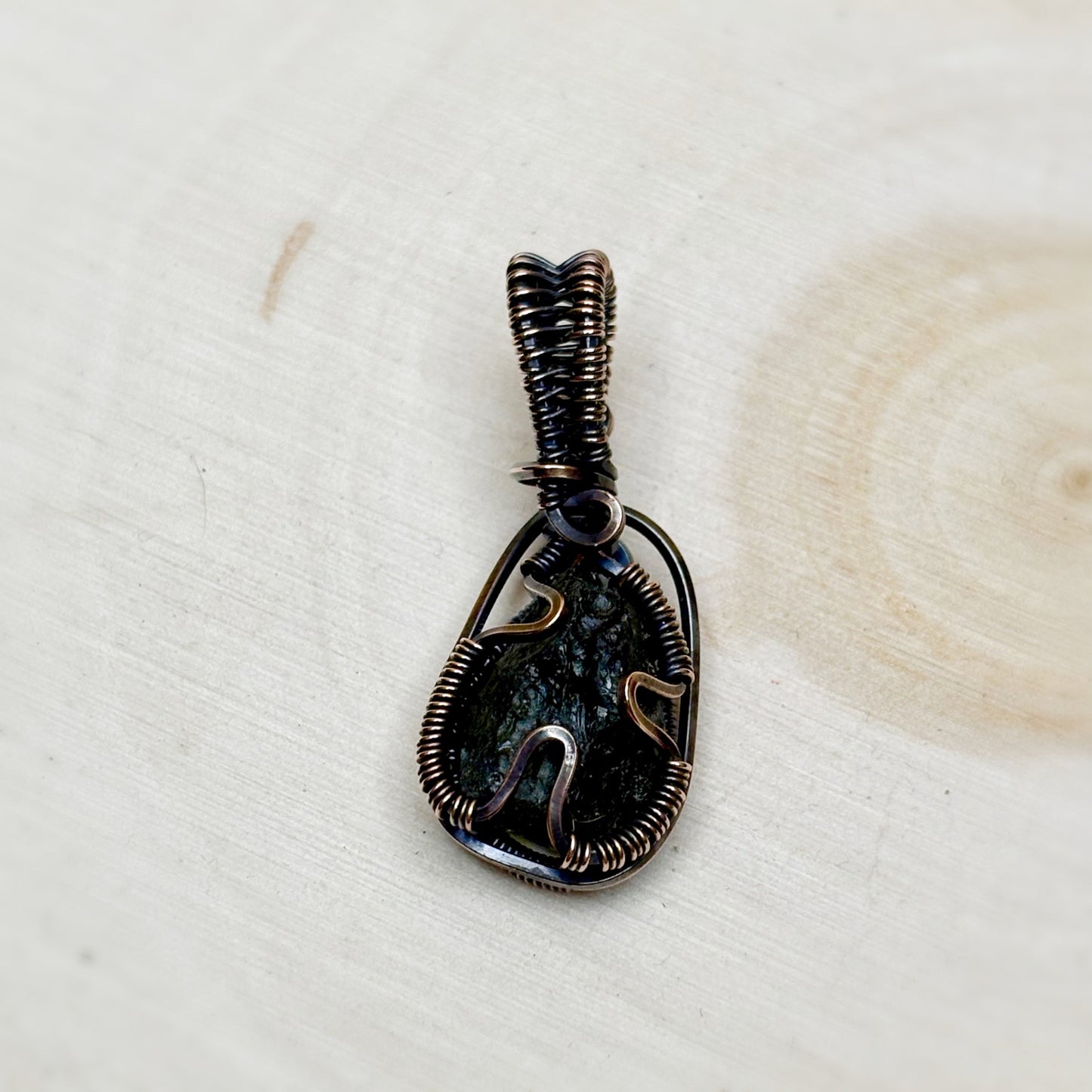 Back side of Moldavite wire wrap pendant genuine tektite