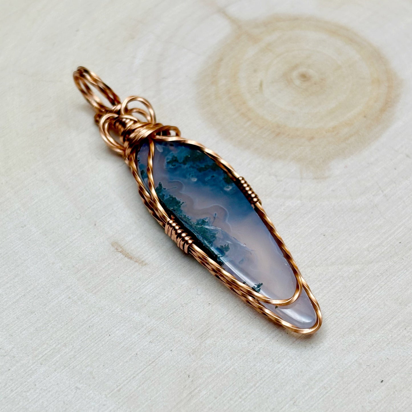 Copper jewelry back side view on a wooden background