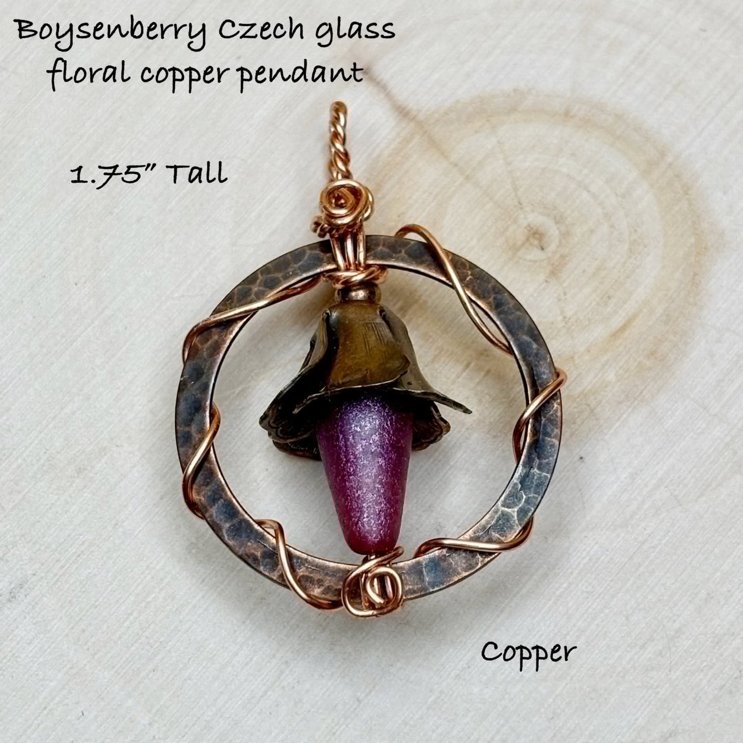 Boysenberry Czech glass floral copper pendant on a textured white background