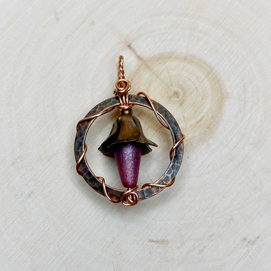 Copper pendant with a Czech glass drop on a textured white background