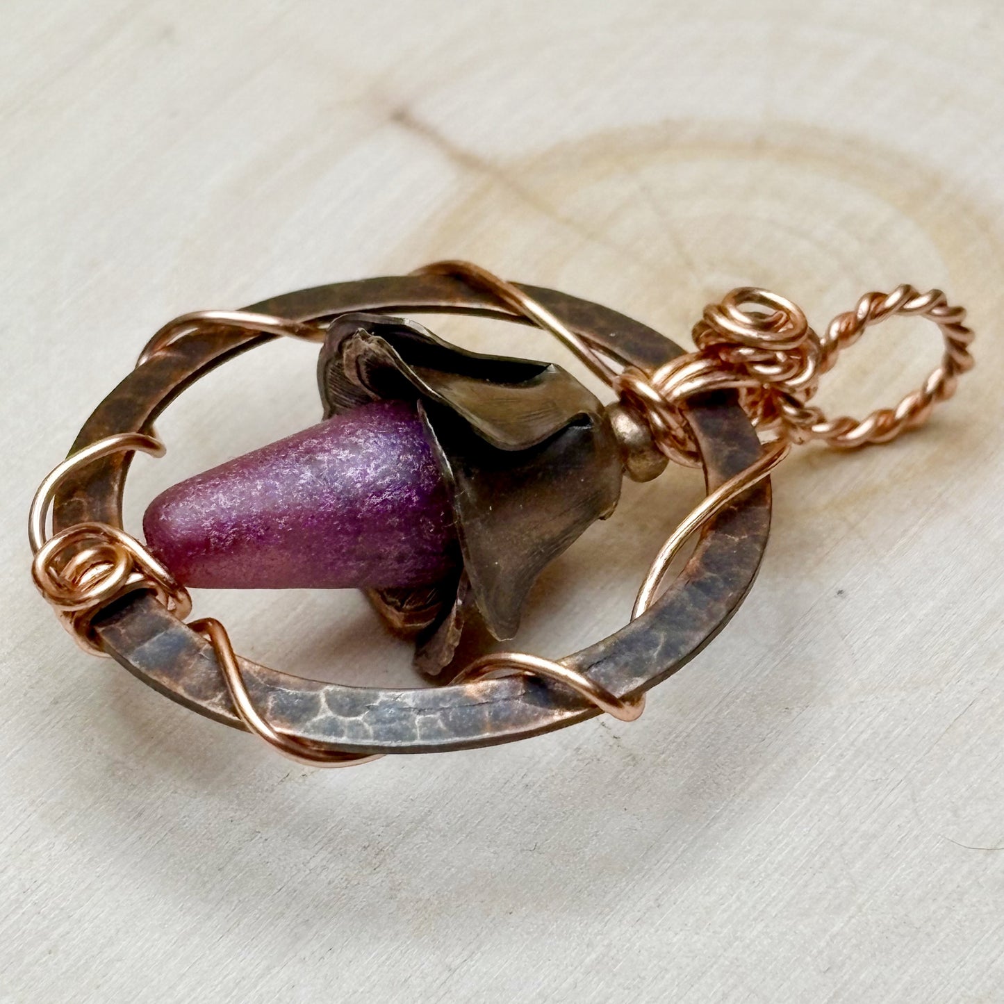 Floral pendant in copper on a light background
