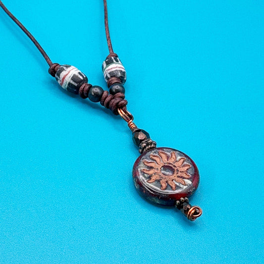 Necklace with decorative pendant on a blue background