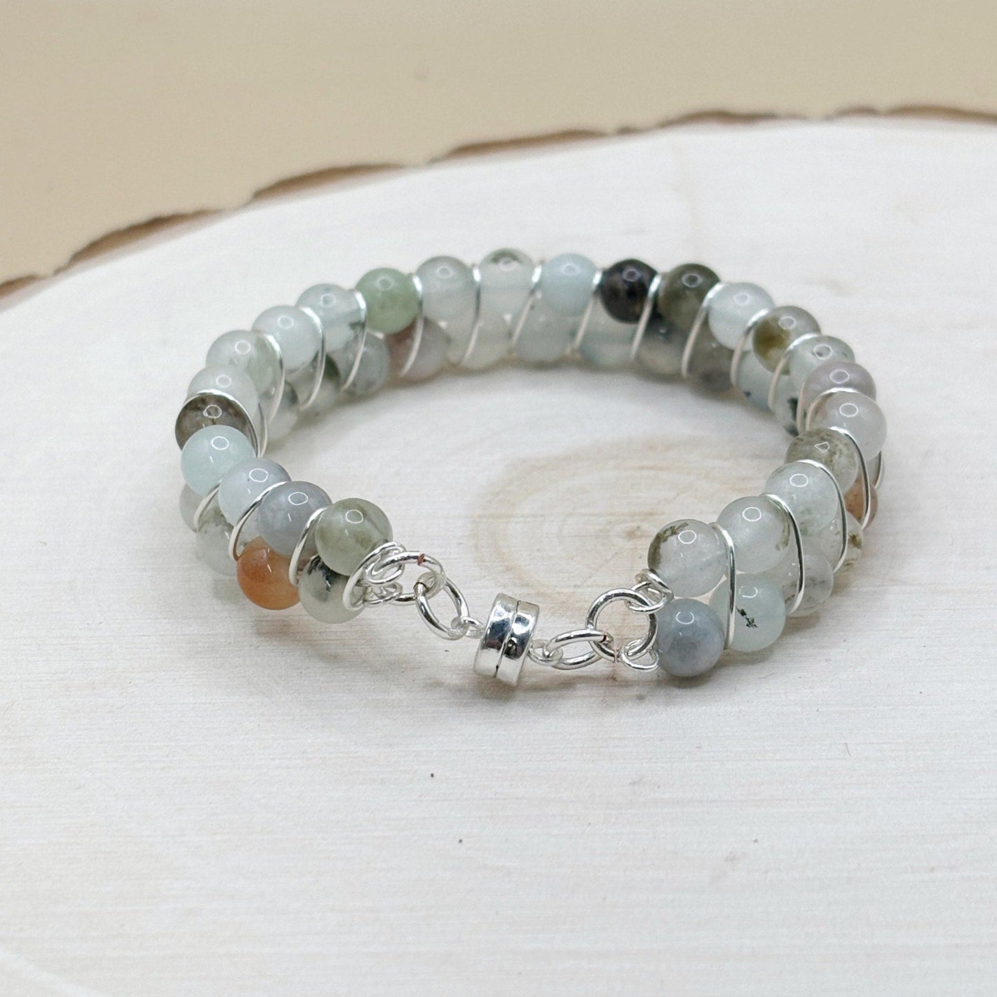 Blue agate crystal Beaded bracelet with silver accents on a white surface