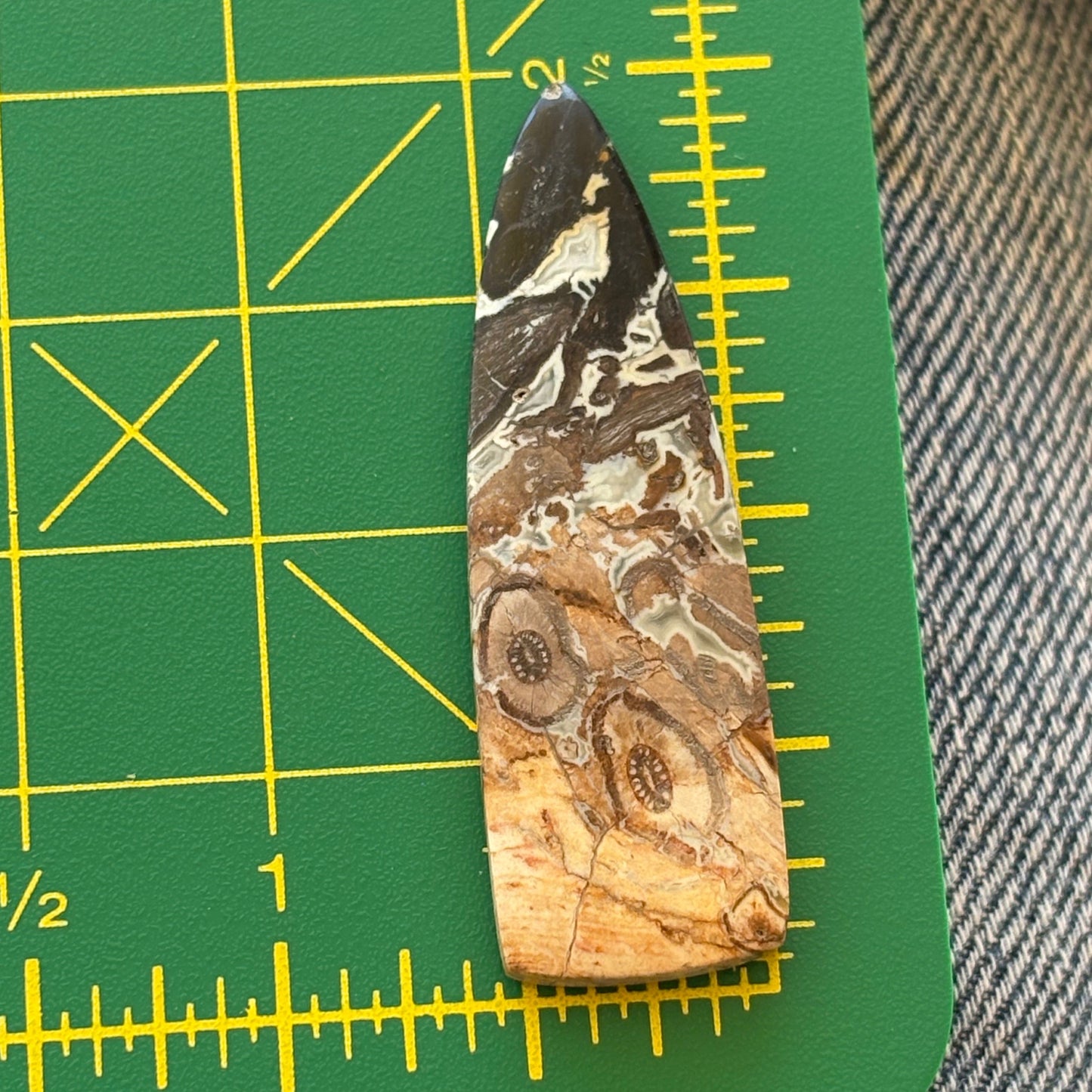 Marbled stone on a green cutting mat with yellow grid lines