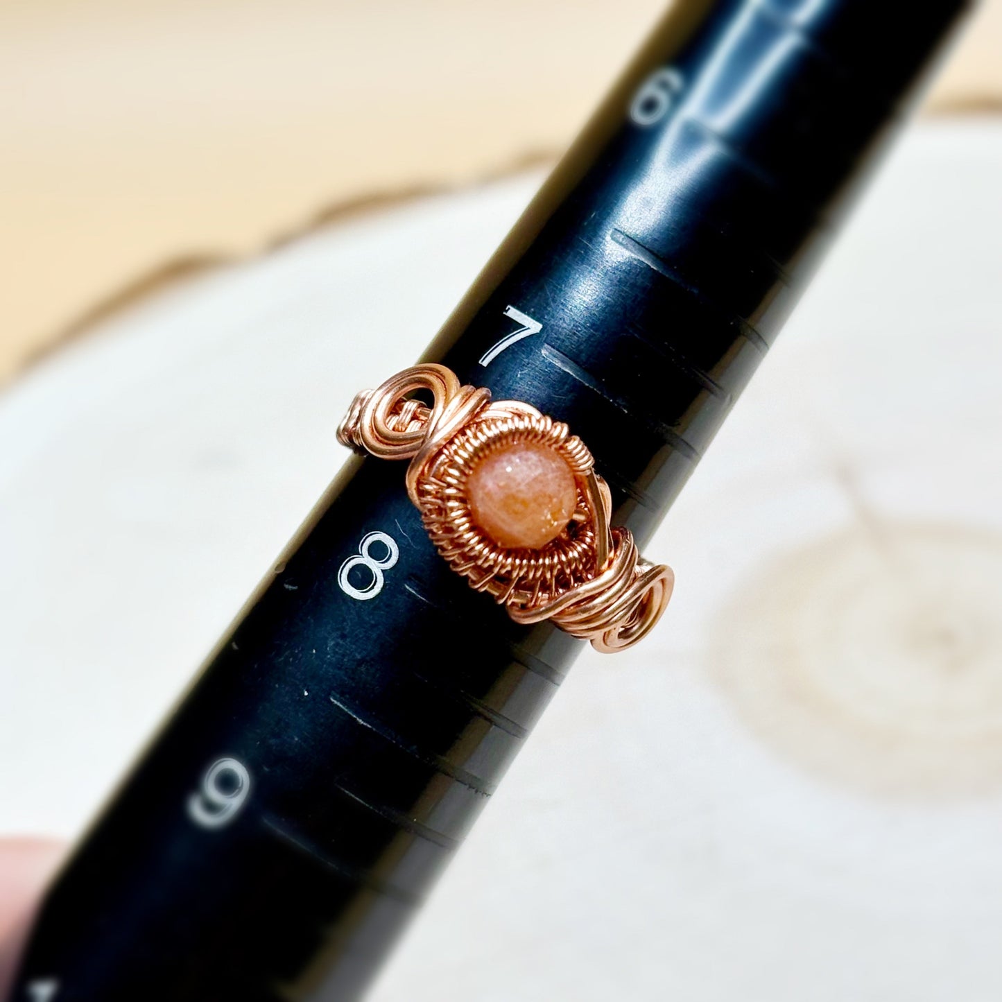 Ring mandrel with copper ring displaying size of the ring 7 and a half