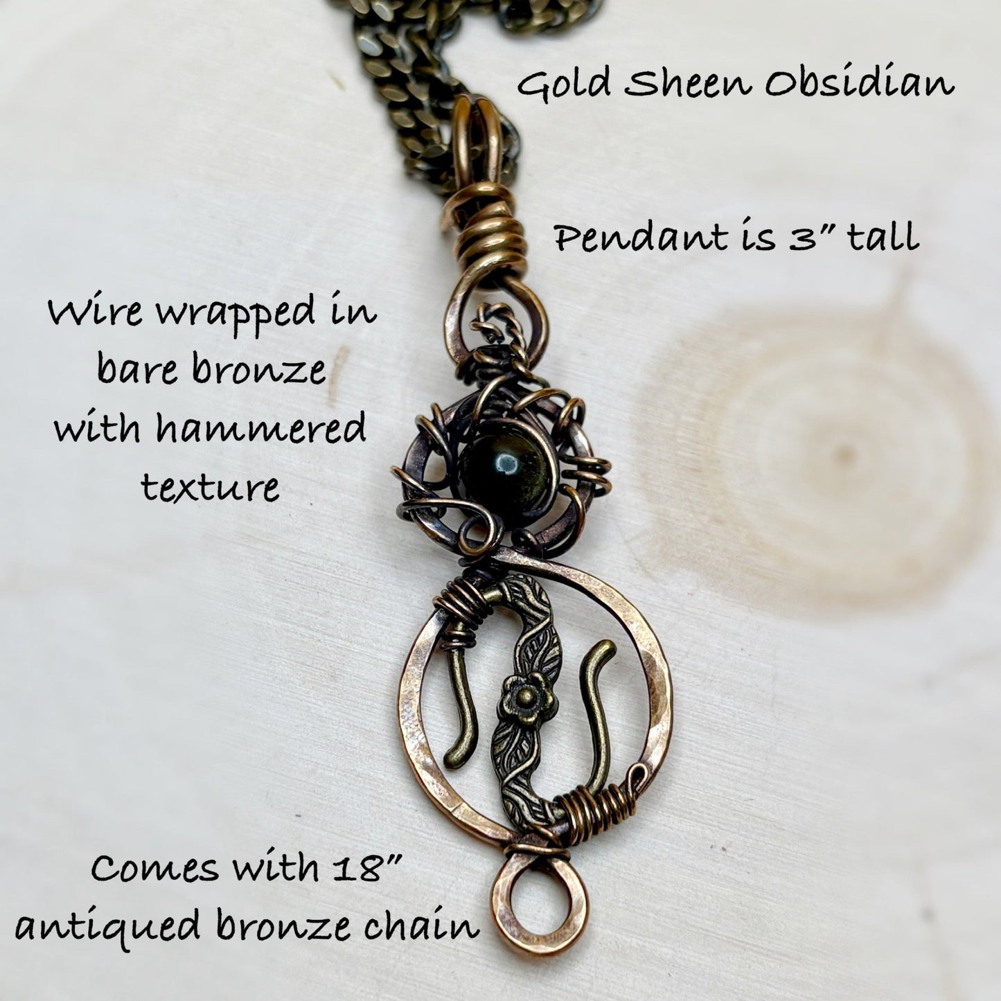 Gold Sheen Obsidian pendant with wire wrapping and hammered texture on a white background