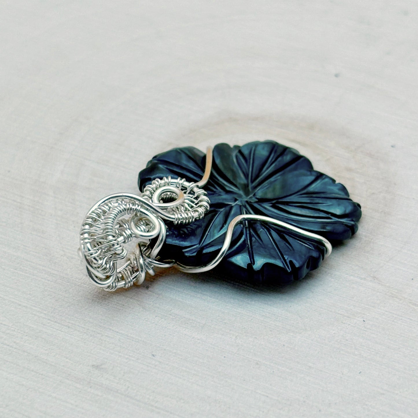 blue flower shaped wire wrap pendant with silver wire
