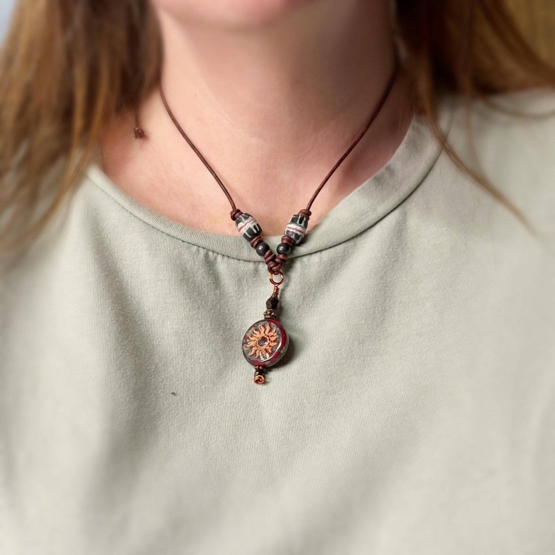 Necklace with a pendant worn by a person on a plain background
