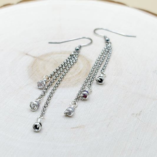 Silver chain earrings on a light background