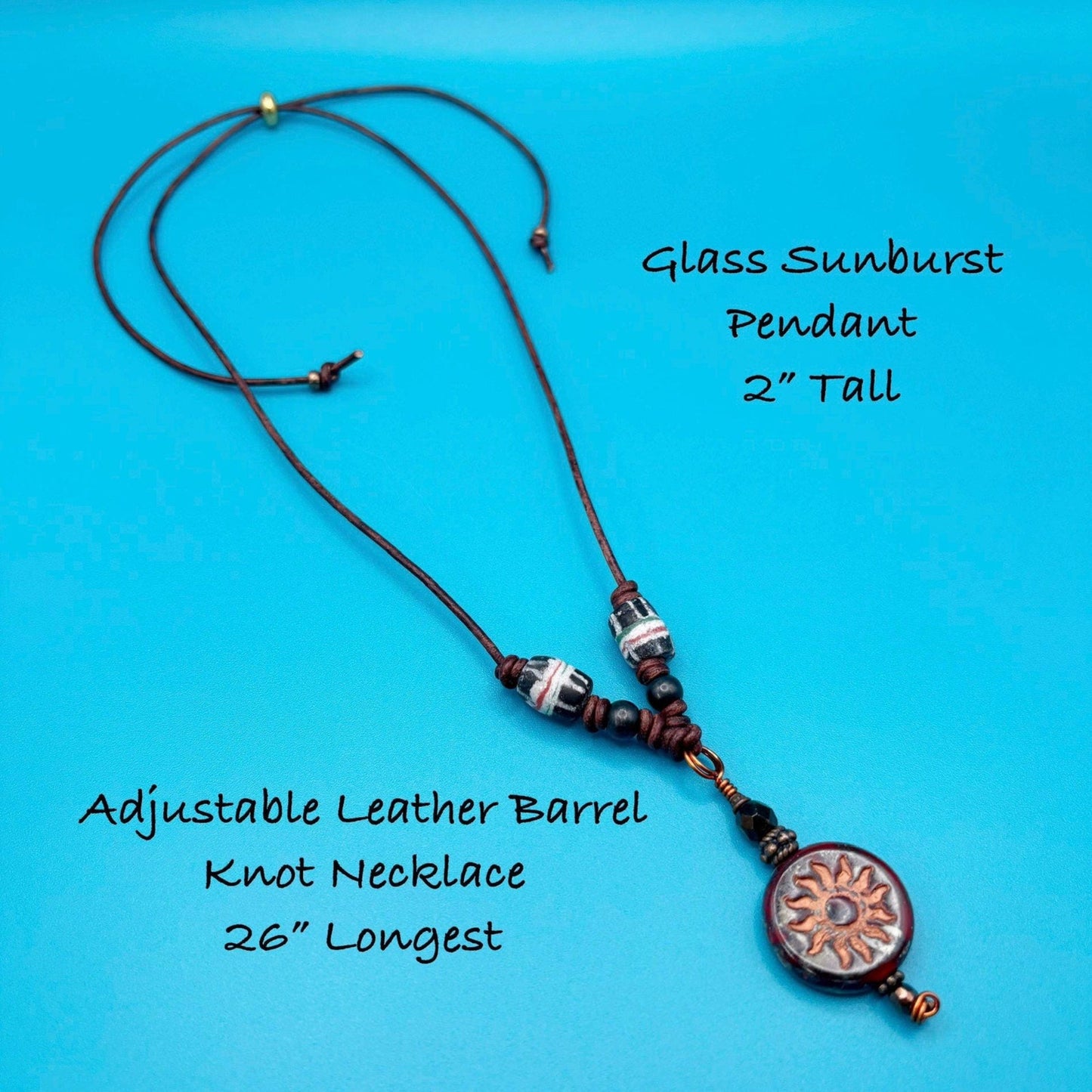 Necklace with glass sunburst pendant and adjustable leather barrel knot on a blue background