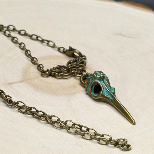 Necklace with a bird skull pendant on a light background