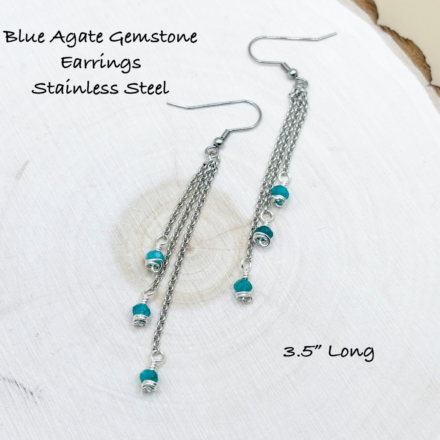 Blue Agate Gemstone Earrings with Stainless Steel on a wood fabric background