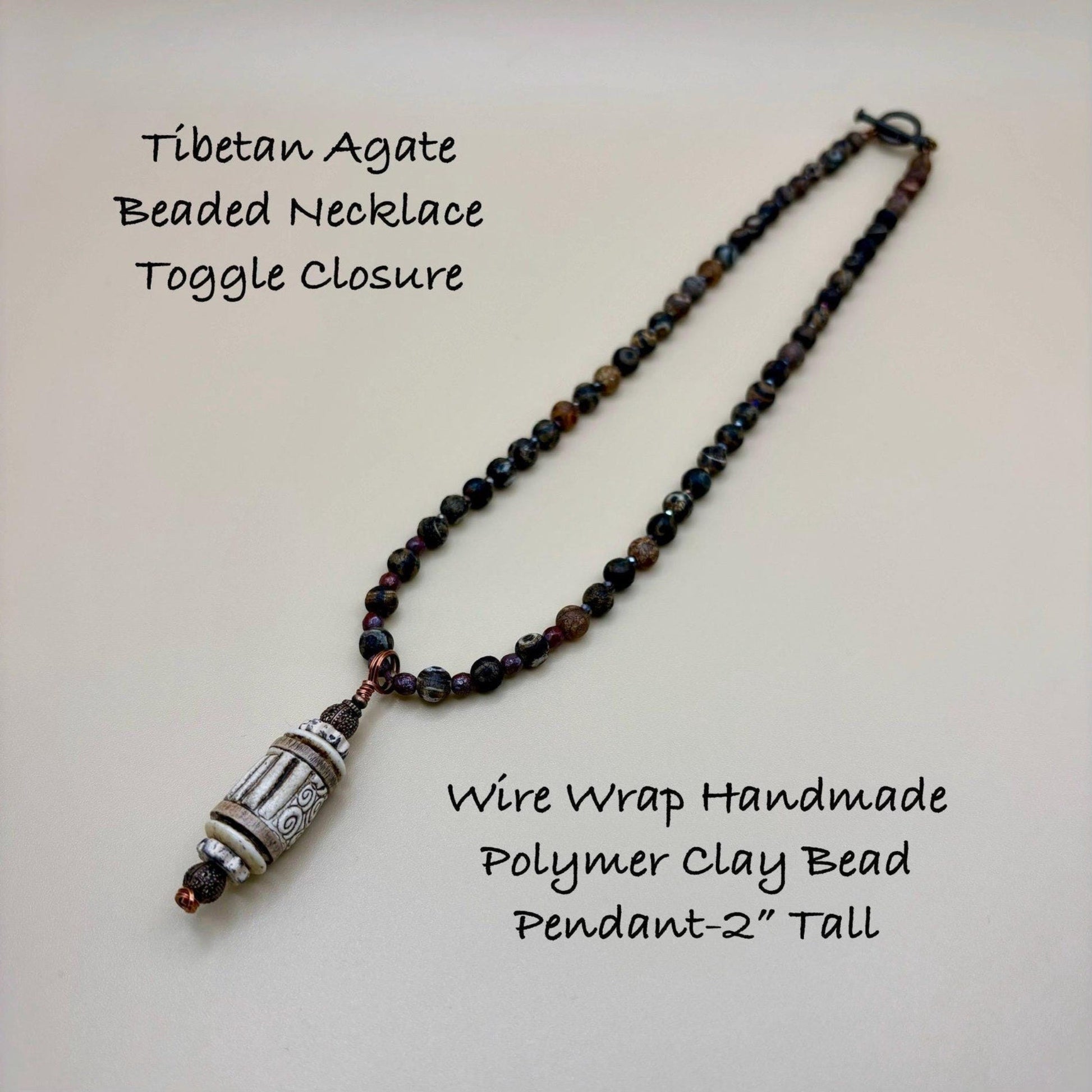 Tibetan Agate Beaded Necklace with Wire Wrap Handmade Polymer Clay Bead Pendant on a light background
