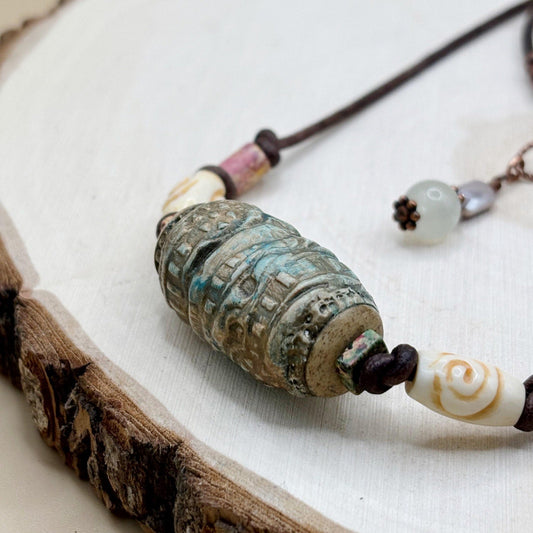 Necklace with textured beads on a wooden surface-p