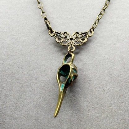 Bronze and green pendant necklace on a light gray background