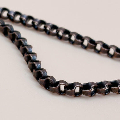 Close-up of a metal chain on a light background