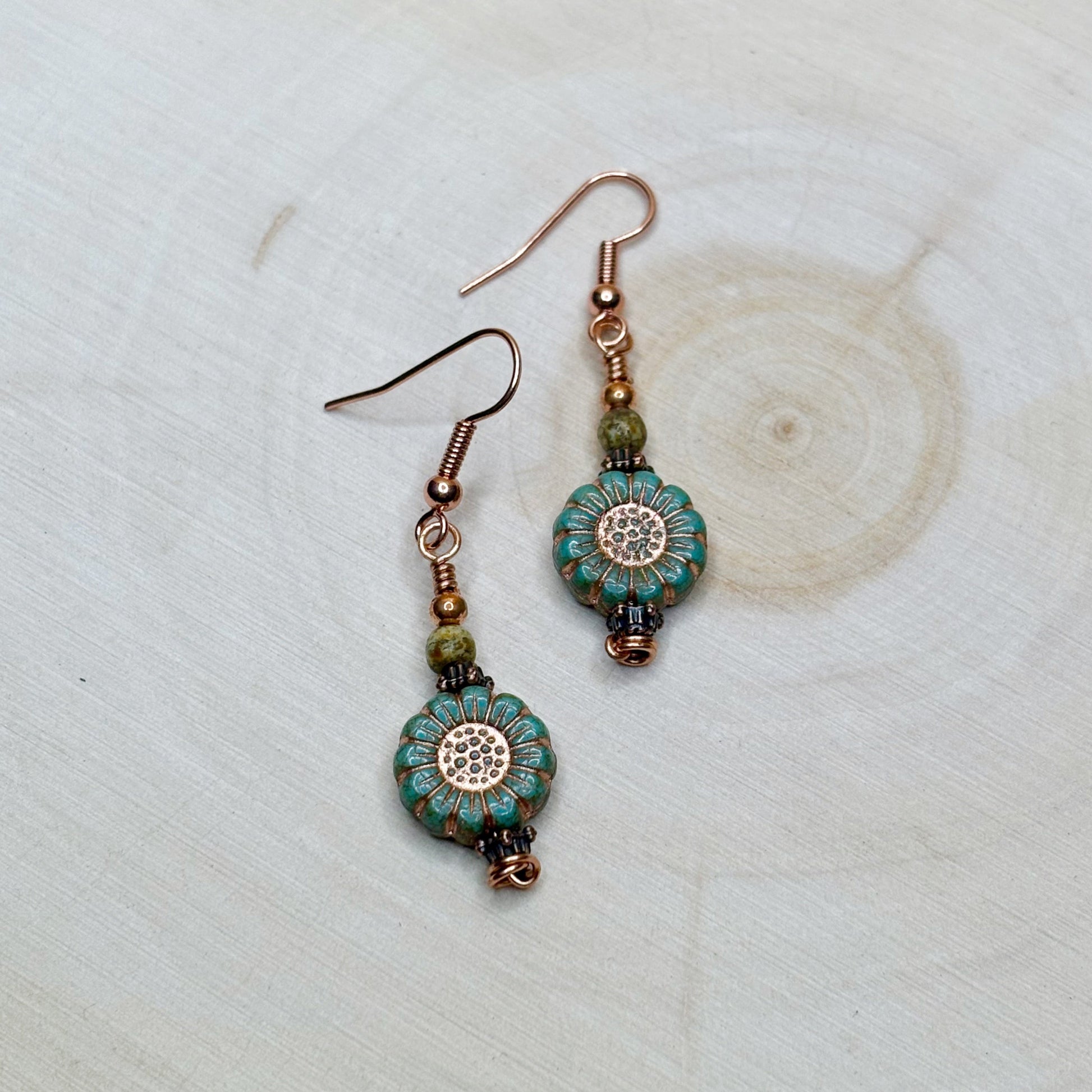 Pair of beaded earrings on a light wooden surface