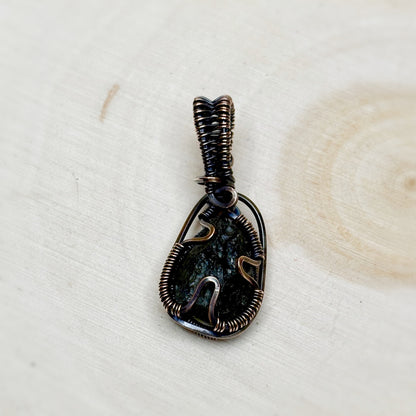 Back side of Moldavite wire wrap pendant genuine tektite