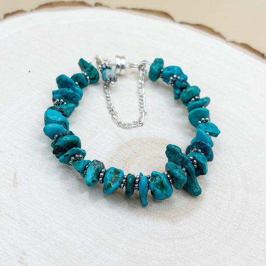 Turquoise beaded bracelet on a white wood surface