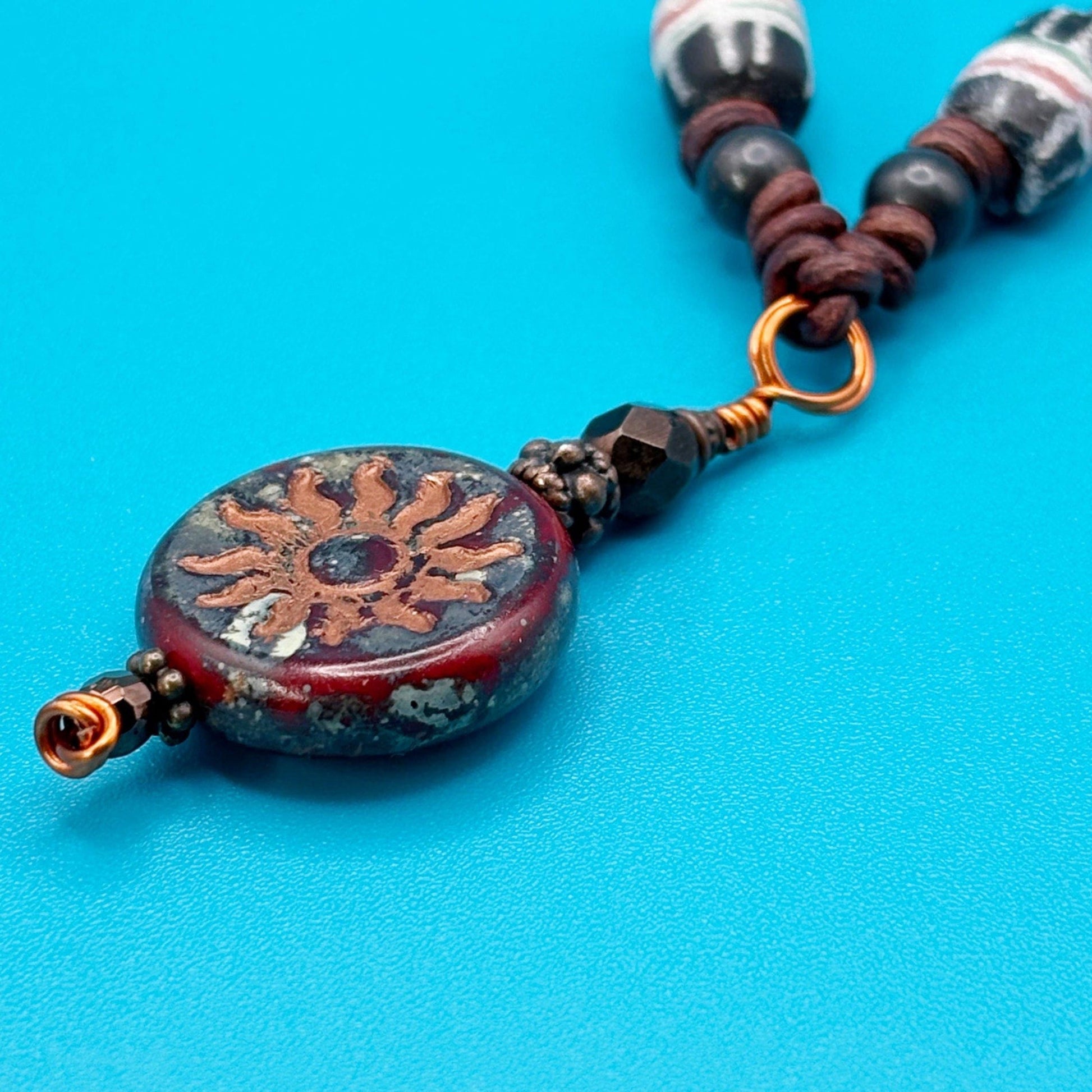 Necklace with a decorative pendant on a blue background