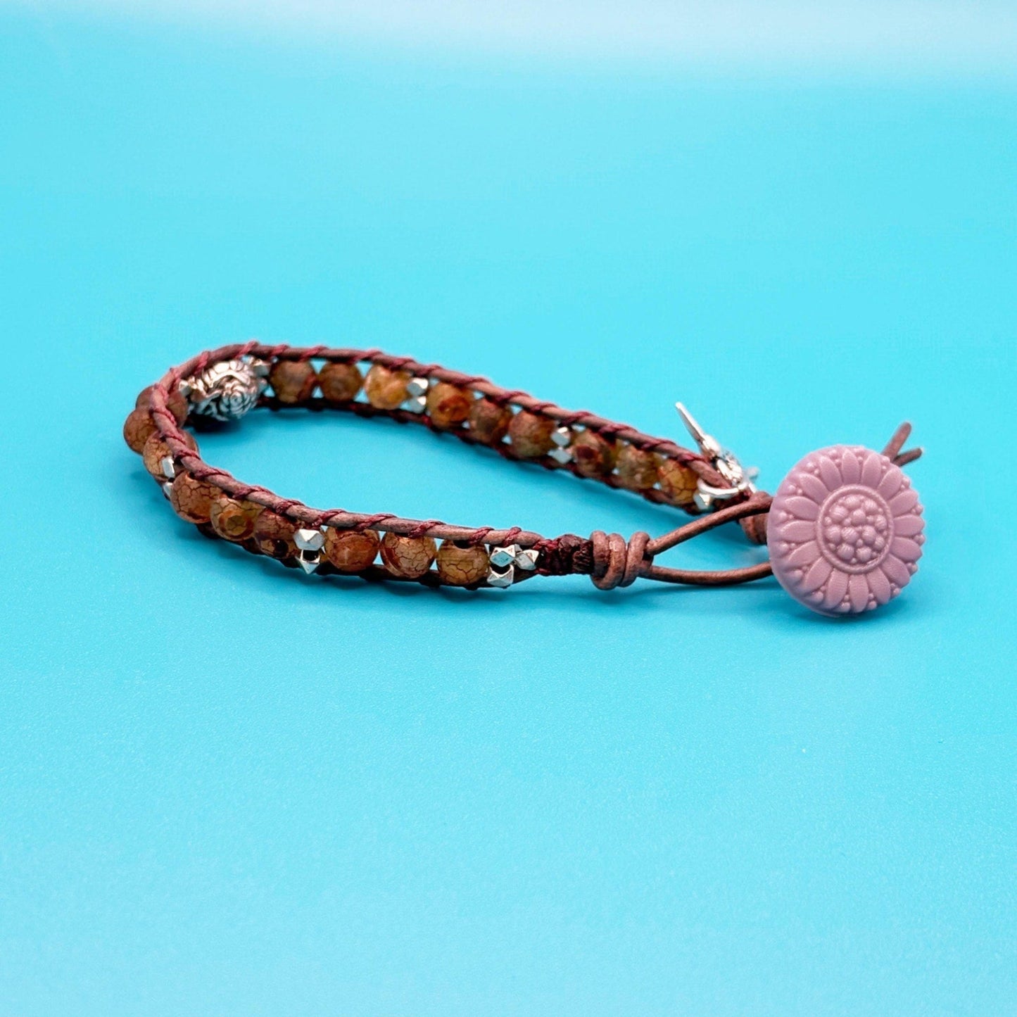 Bracelet with a purple button on a blue background