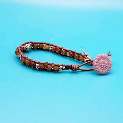 Bracelet with a purple button on a blue background