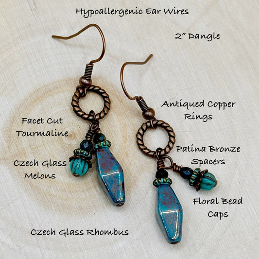 Pair of earrings with detailed specifications on a textured beige background