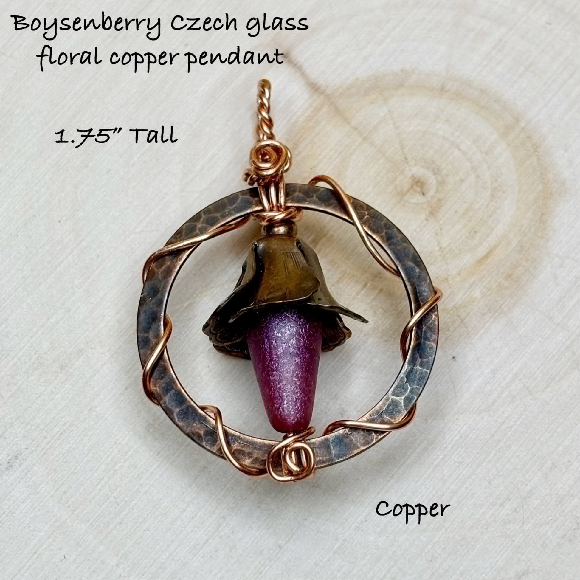 Boysenberry Czech glass floral copper pendant on a textured white background