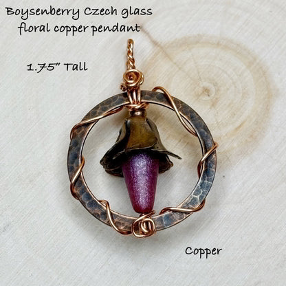 Boysenberry Czech glass floral copper pendant on a textured white background