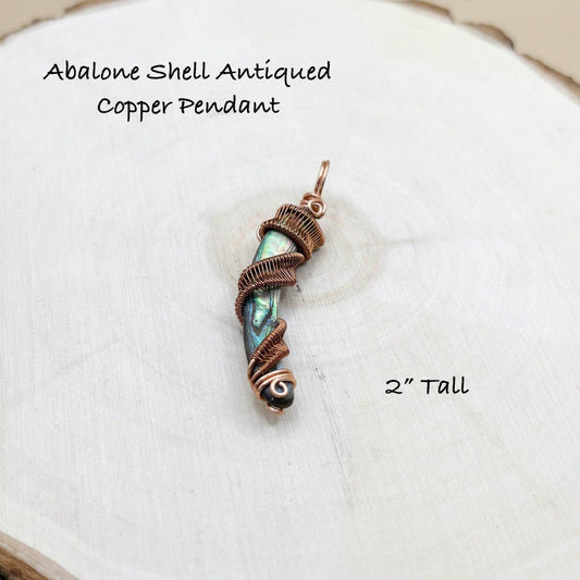 Abalone shell antiqued copper pendant on a white background