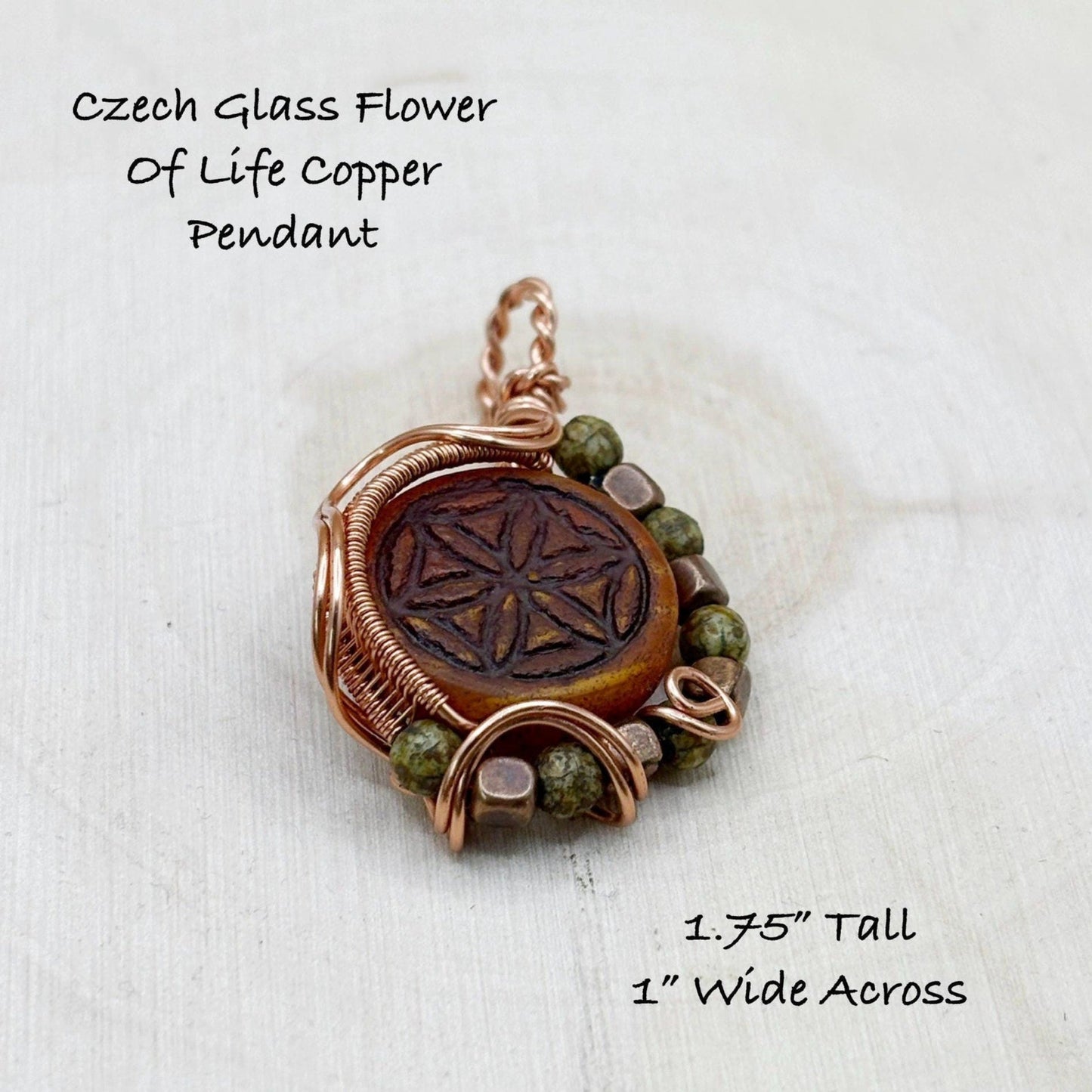 Czech glass flower of life copper pendant with dimensions on a wooden background