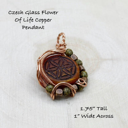 Czech glass flower of life copper pendant with dimensions on a wooden background
