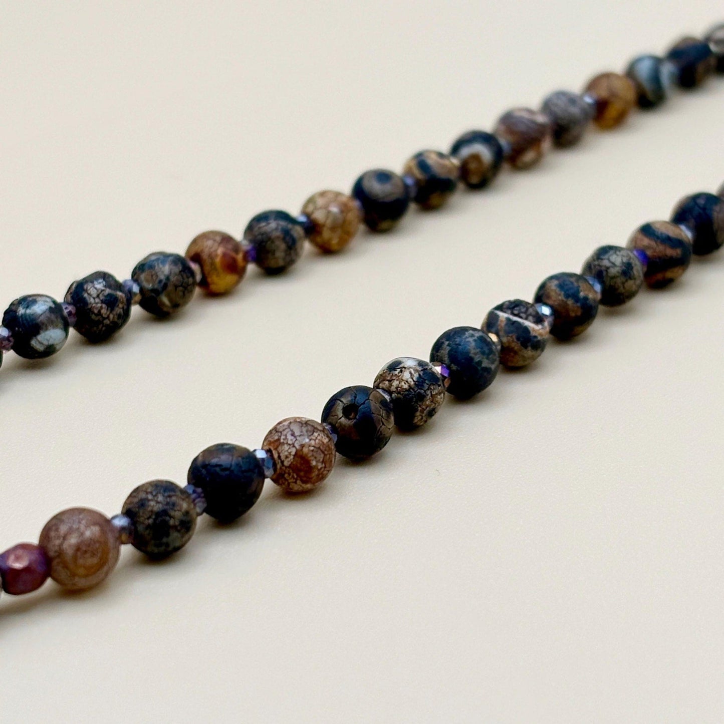 Necklace with multicolored beads on a light background