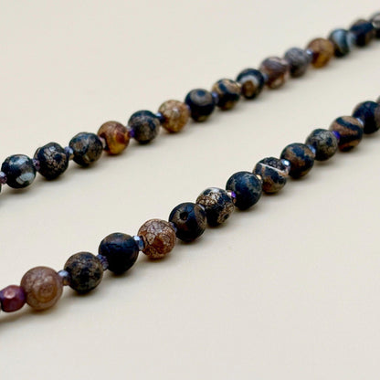 Necklace with multicolored beads on a light background