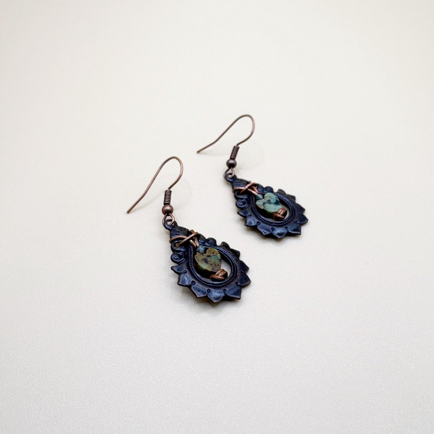 Pair of decorative earrings on a light beige background