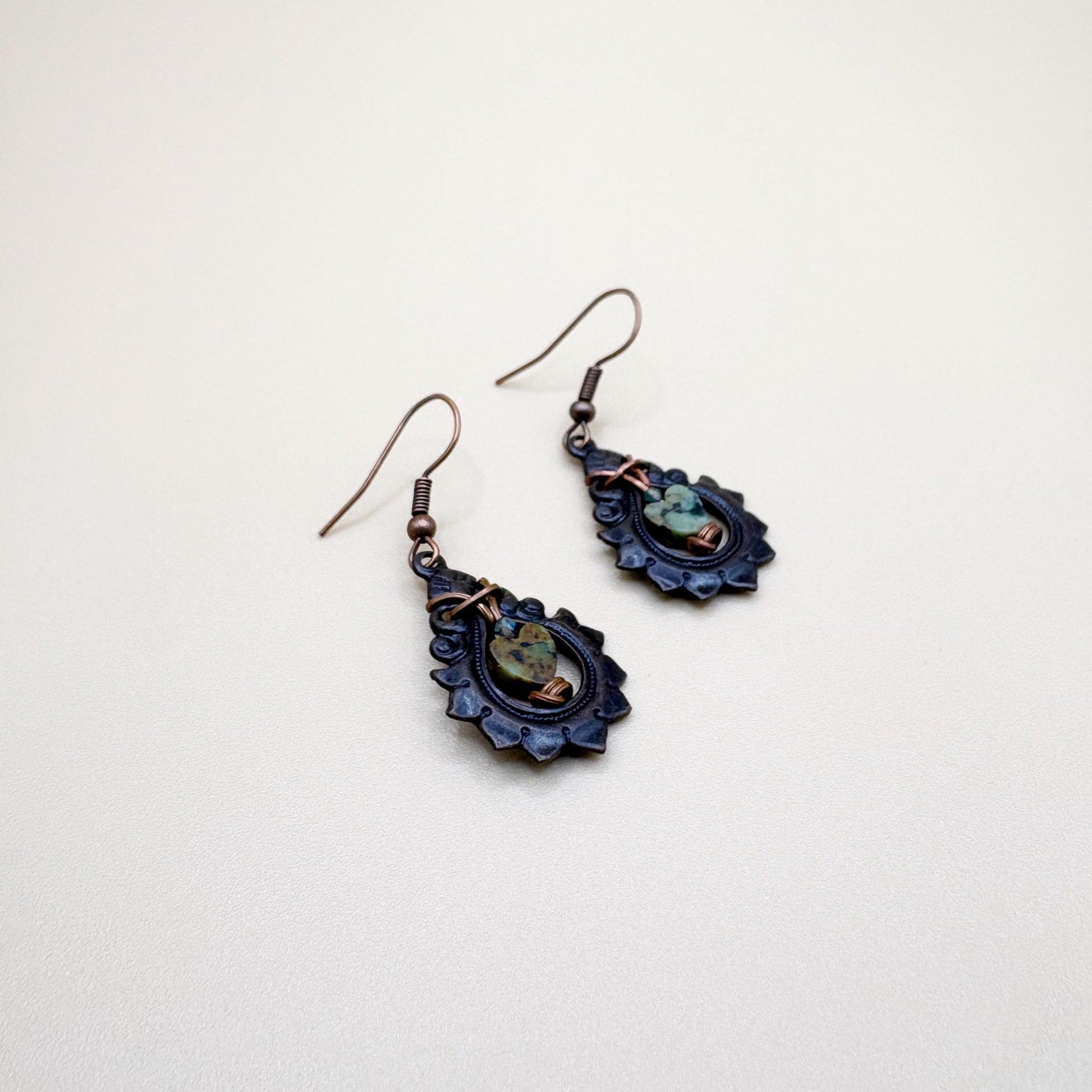Pair of decorative earrings on a light beige background
