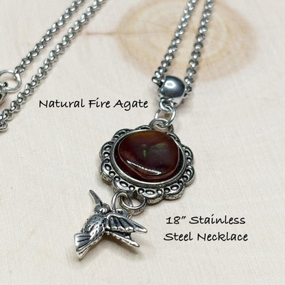 Necklace with natural fire agate pendant and bird charm on a light background