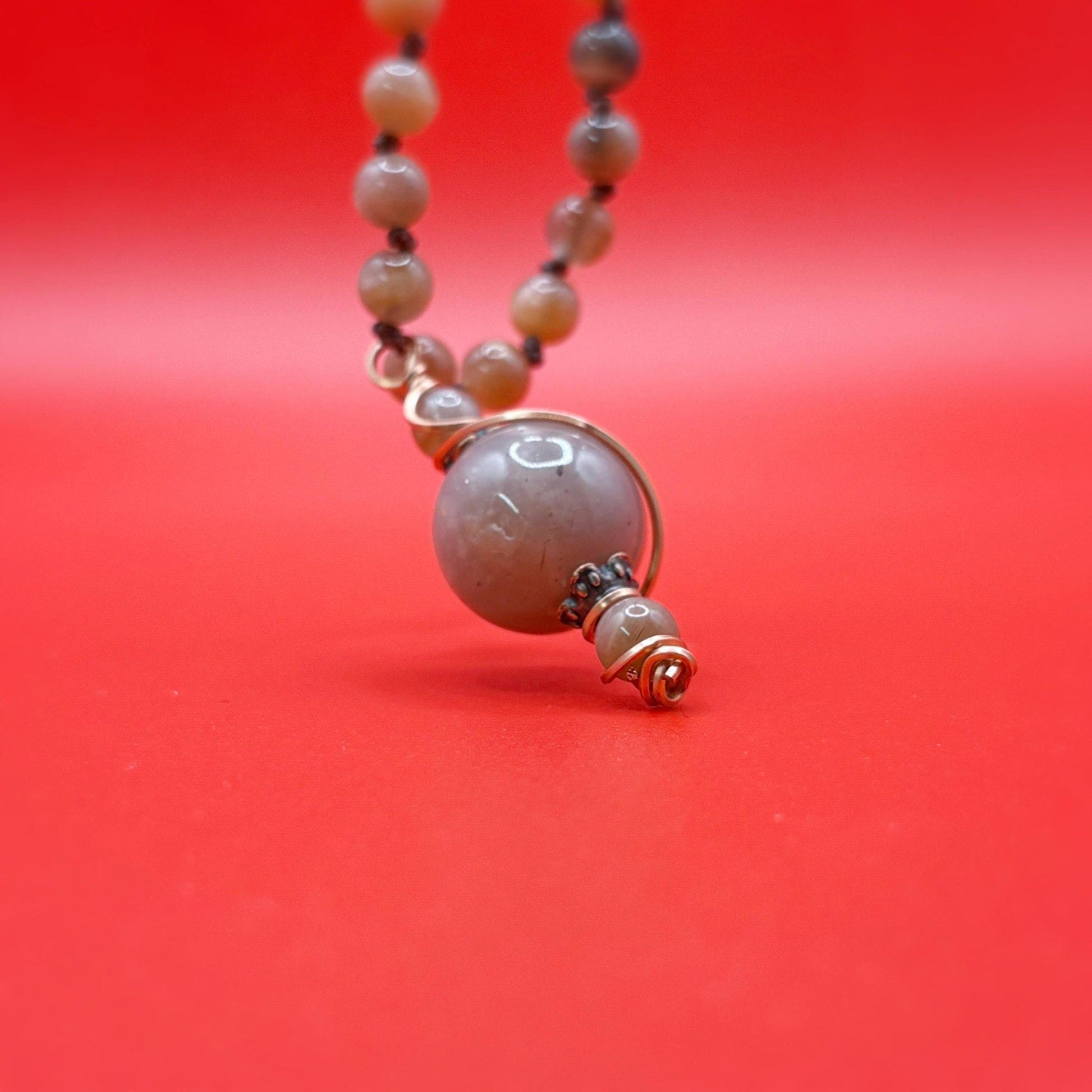 Necklace with a large pendant on a red background