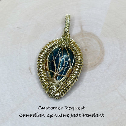 Gold-wrapped pendant with green gemstone on a wooden background