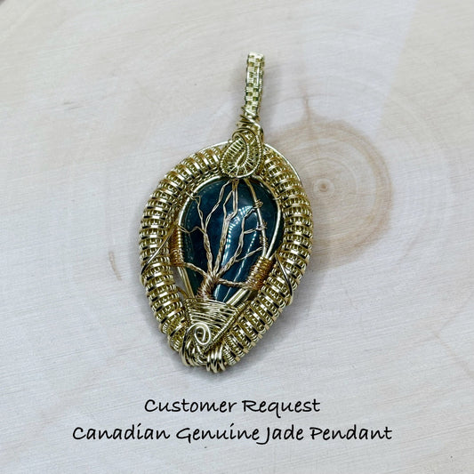 Gold-wrapped pendant with green gemstone on a wooden background