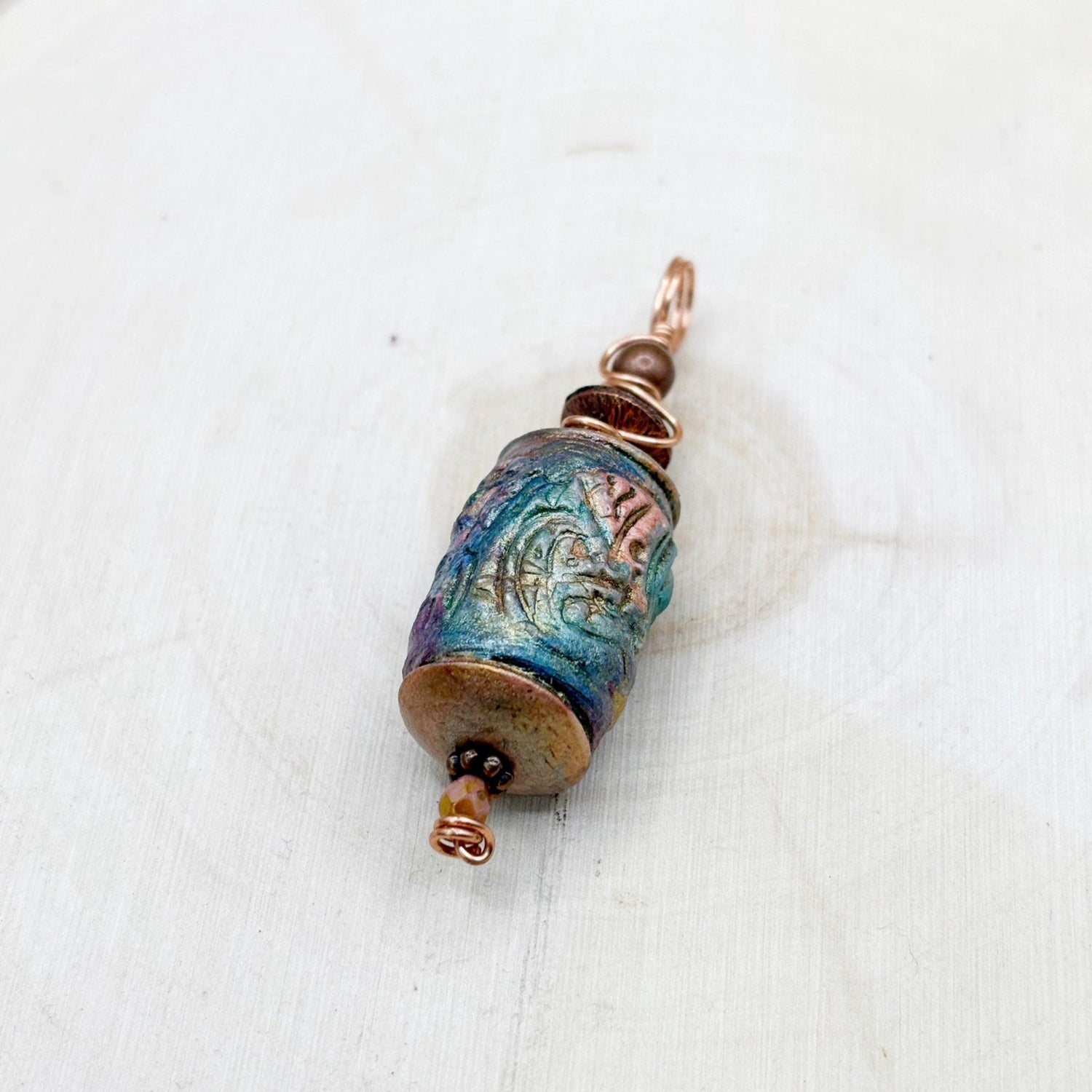 Decorative pendant with blue and gold colors on a white background