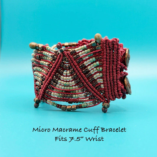 Micro macrame cuff bracelet with beads on a blue background