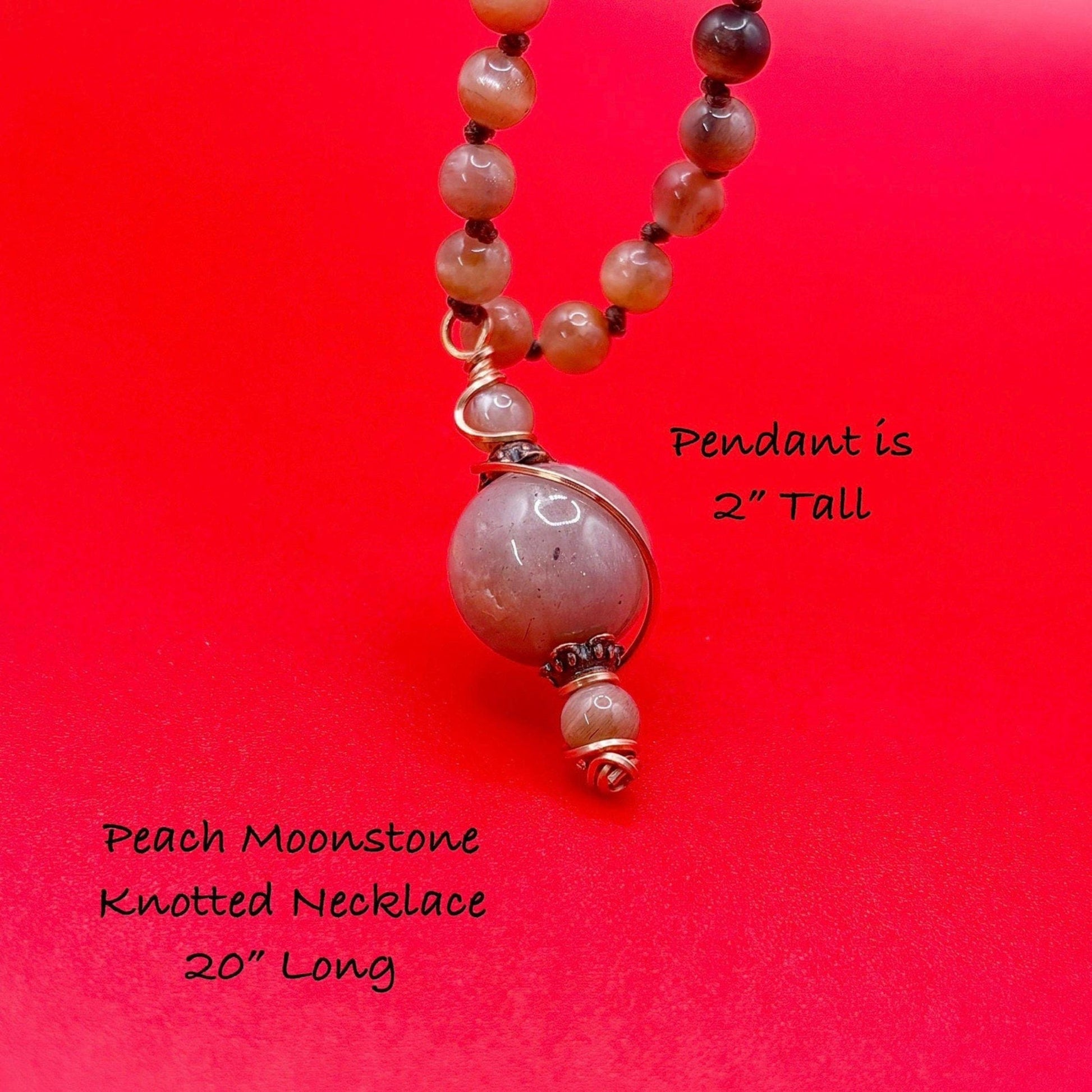 Peach Moonstone knotted necklace with a 2-inch pendant on a red background