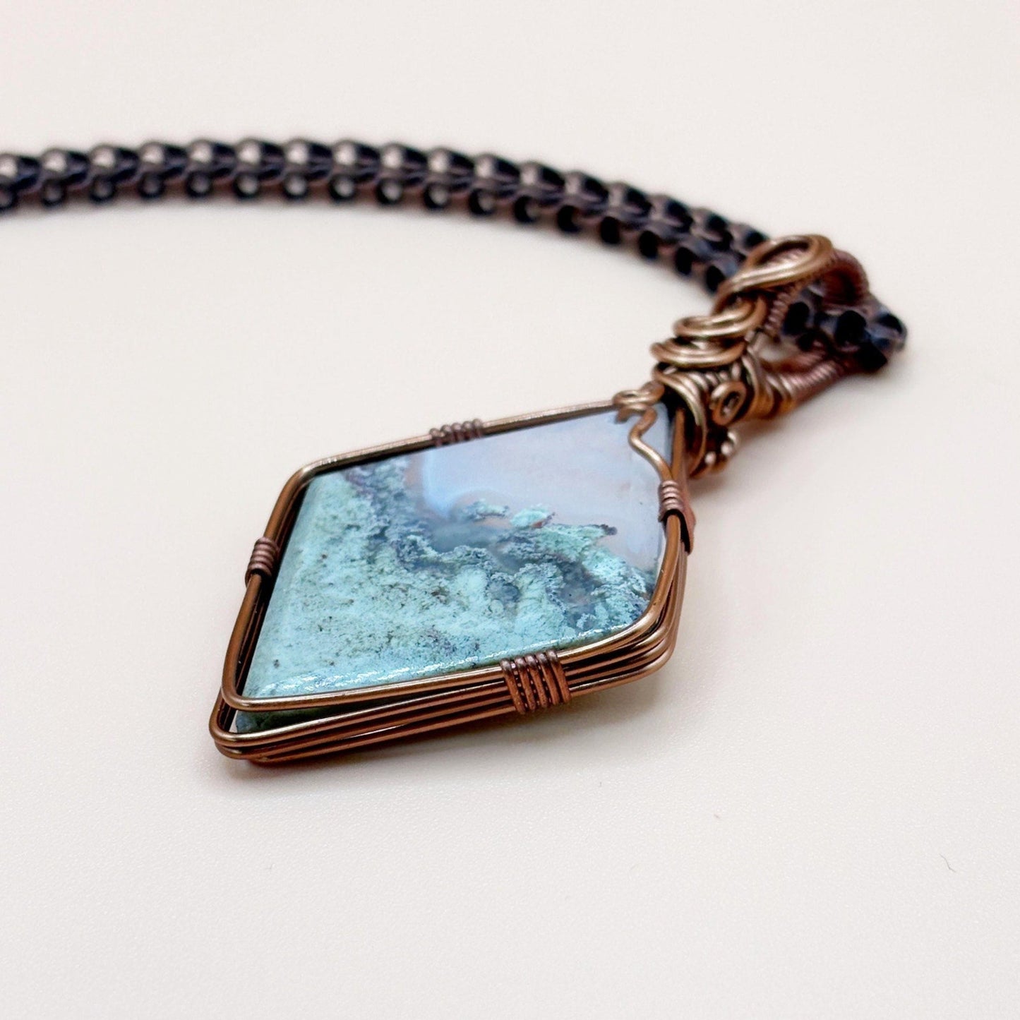 Necklace with a turquoise stone pendant on a white background