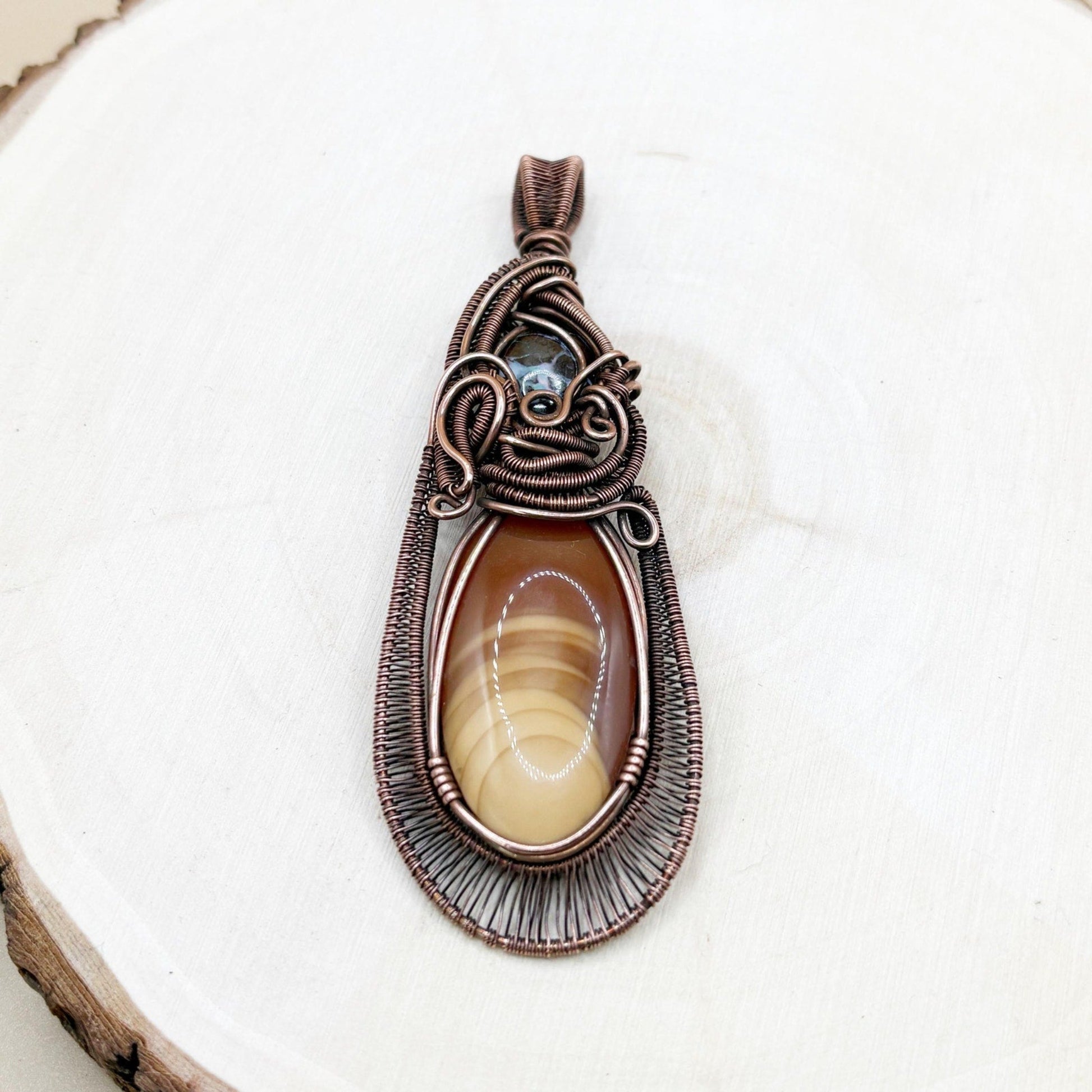 Decorative pendant with a stone on a white background