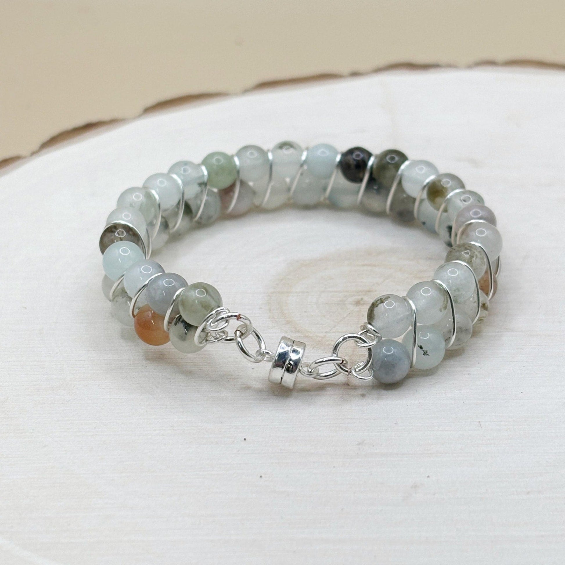 Blue agate crystal Beaded bracelet with silver accents on a white surface