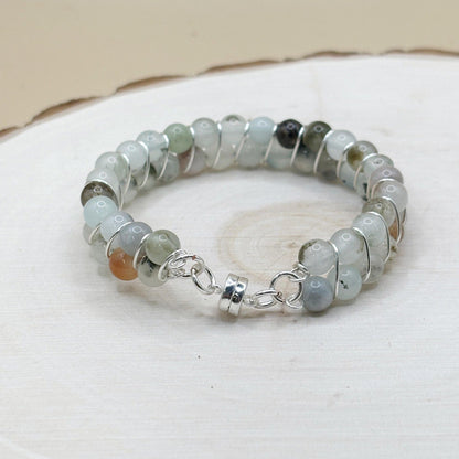 Blue agate crystal Beaded bracelet with silver accents on a white surface