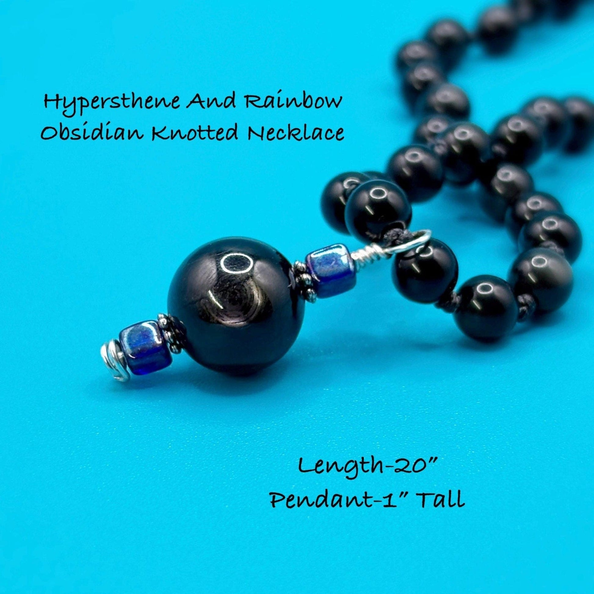 Black beaded necklace with blue accents on a blue background