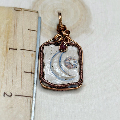 Decorative pendant with a moon design on a white background