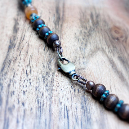 Necklace sitting on a wood background showing the lobster claw style clasp
